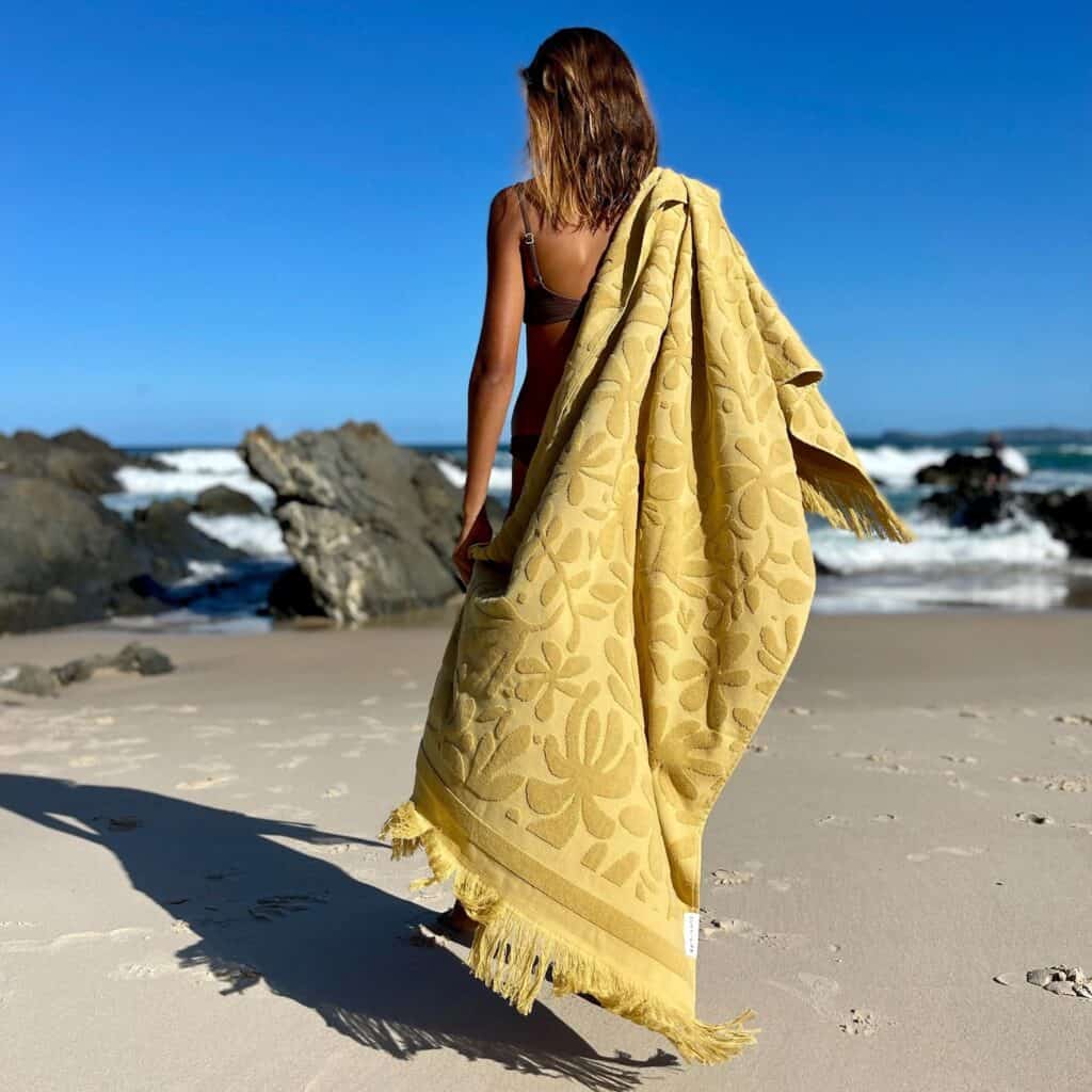 Celebrate Sizzling Summer with this Luxe Towel in Mango Bay Golden Mustard by Sunnylife.